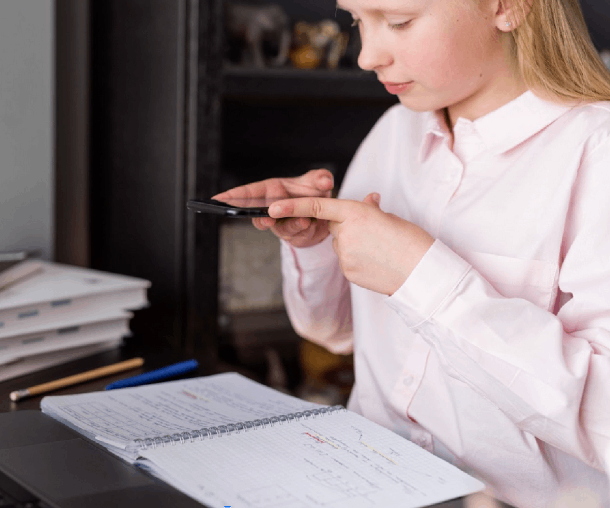 A woman scrolls through her phone, tapping in her assignment details to place an order for academic help.